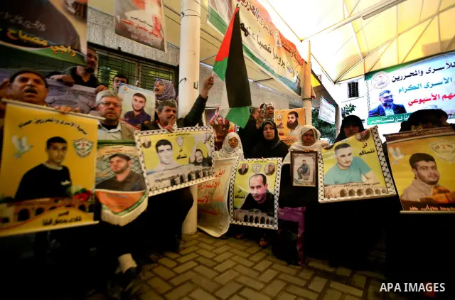 Palestinian relatives prisoners attend a protest calling for the release of their sons held in Israeli jails next the International Red Cross in Gaza City, Gaza Strip, on Apr. 02, 2012. Photo by Ali Jadallah