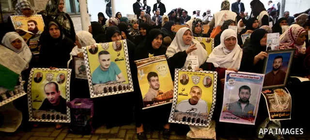 Palestinian relatives prisoners attend a protest calling for the release of their sons held in Israeli jails next the International Red Cross in Gaza City, Gaza Strip, on Apr. 02, 2012. Photo by Ali Jadallah