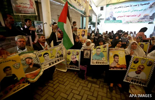 Palestinian relatives prisoners attend a protest calling for the release of their sons held in Israeli jails next the International Red Cross in Gaza City, Gaza Strip, on Apr. 02, 2012. Photo by Ali Jadallah