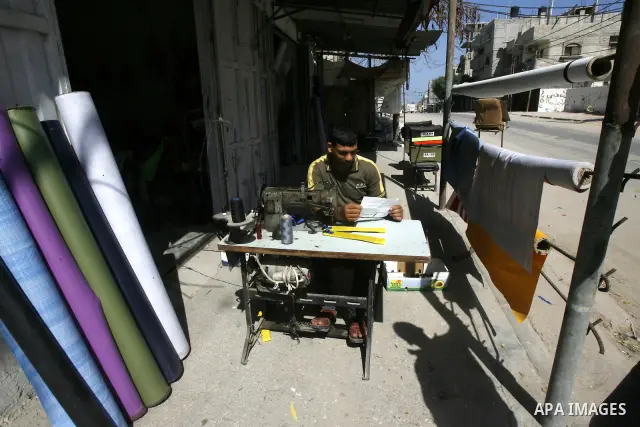 Palestinians read sheets which were thrown by Israeli aeroplane warning the Palestinians from reaching the no-go zone on the border with Israel,in the Rafah on the southern Gaza Strip on April 2,2012. Photo by Eyad Al Ba...