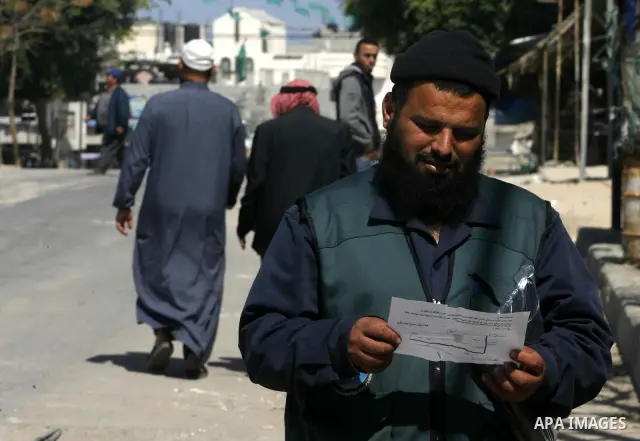 Palestinians read sheets which were thrown by Israeli aeroplane warning the Palestinians from reaching the no-go zone on the border with Israel,in the Rafah on the southern Gaza Strip on April 2,2012. Photo by Eyad Al Ba...