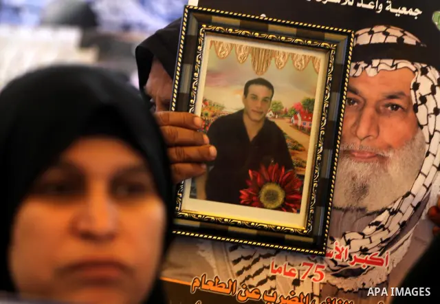 Palestinian relatives prisoners attend a protest calling for the release of their sons held in Israeli jails next the International Red Cross in Gaza City, Gaza Strip, on Apr. 02, 2012. Photo by Mohammed Asad