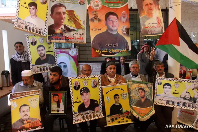 Palestinian relatives prisoners attend a protest calling for the release of their sons held in Israeli jails next the International Red Cross in Gaza City, Gaza Strip, on Apr. 02, 2012. Photo by Mohammed Asad
