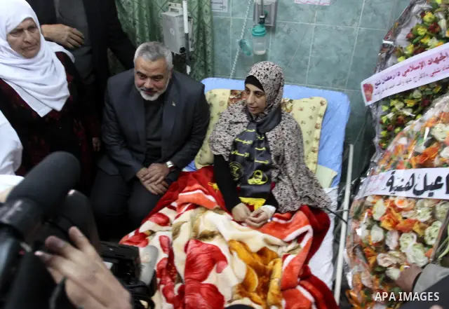 Palestinian Hamas premier in the Gaza Strip, Ismail Haniya visits Palestinian prisoner Hanaa Shalabi, who spent 43 days on hunger strike in an Israeli prison, in Al-Shefa hospital in Gaza City on April 2, 2012. Shalabi,...