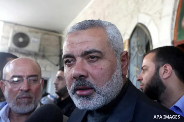Palestinian prime minister in Gaza Strip, Ismail Haniya participates in the funneral of the three children who were killed in a domestic fire during their funeral during their funeral procession in Deir al-Balah in the c...