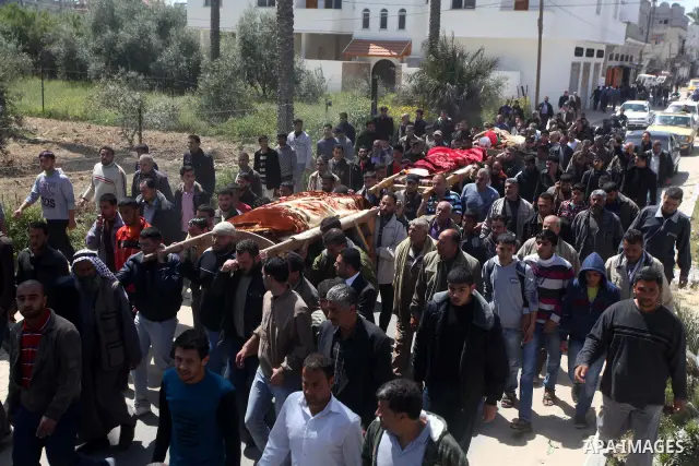 Palestinian mourners carry the bodies of three children who died the previous day in a domestic fire during their funeral in Deir al-Balah in the central Gaza Strip on April 02, 2012. The three Palestinian children, aged...