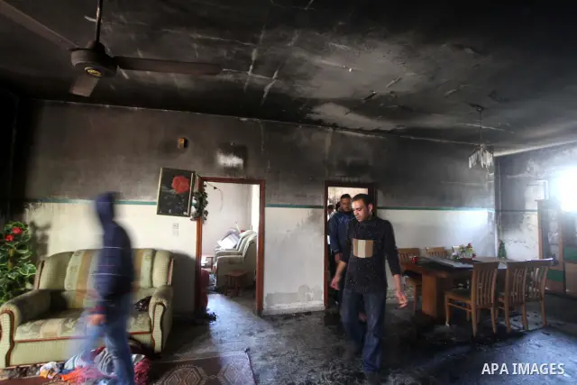 Palestinian men inspect on April 2, 2012 the damage in the bedroom of three children who were killed the previous day in a domestic fire in Deir al-Balah in the central Gaza Strip. The three Palestinian children, aged tw...
