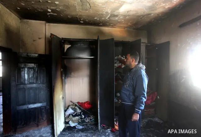 Palestinian men inspect on April 2, 2012 the damage in the bedroom of three children who were killed the previous day in a domestic fire in Deir al-Balah in the central Gaza Strip. The three Palestinian children, aged tw...