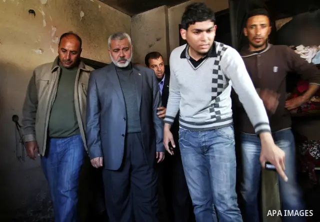 Palestinian prime minister in Gaza Strip, Ismail Haniya inspects the rubble in the room of the three children who were killed in a domestic fire during their funeral during their funeral procession in Deir al-Balah in th...