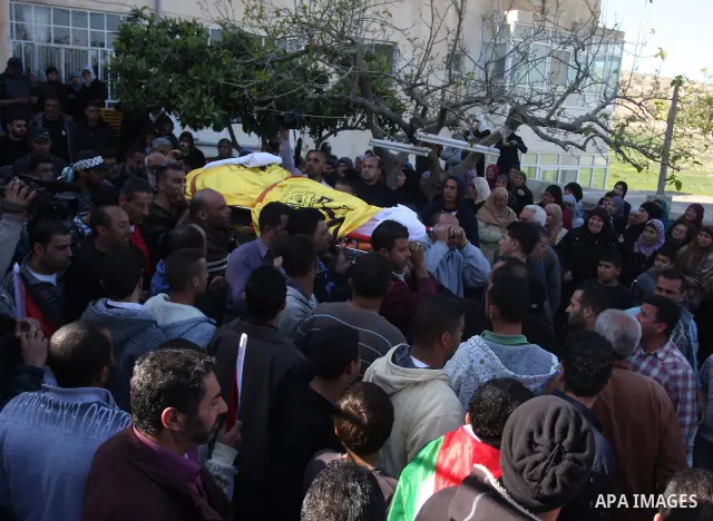 Palestinian mourners carry the body of Rashad Deeb, who was shot and injured by Israeli troops along with his two brothers in the early hours of March 27 in an incident in the West Bank village, 10 kilometres (six miles)...