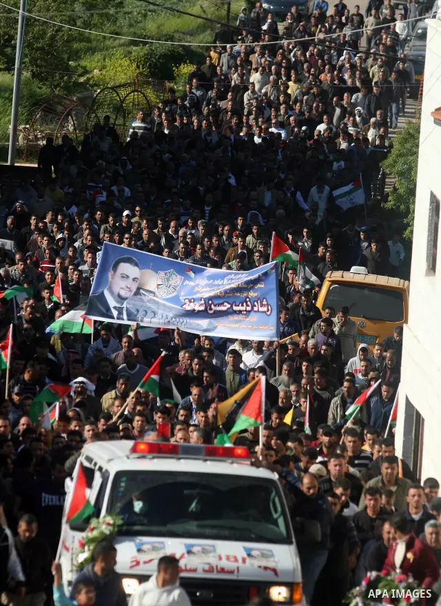 Palestinian mourners carry the body of Rashad Deeb, who was shot and injured by Israeli troops along with his two brothers in the early hours of March 27 in an incident in the West Bank village, 10 kilometres (six miles)...