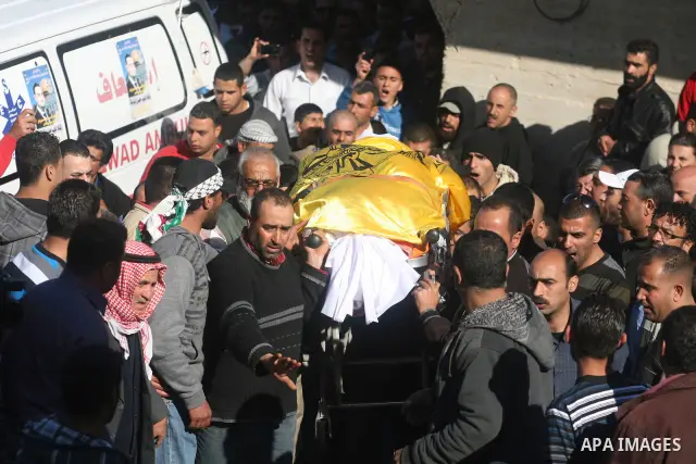 Palestinian mourners carry the body of Rashad Deeb, who was shot and injured by Israeli troops along with his two brothers in the early hours of March 27 in an incident in the West Bank village, 10 kilometres (six miles)...