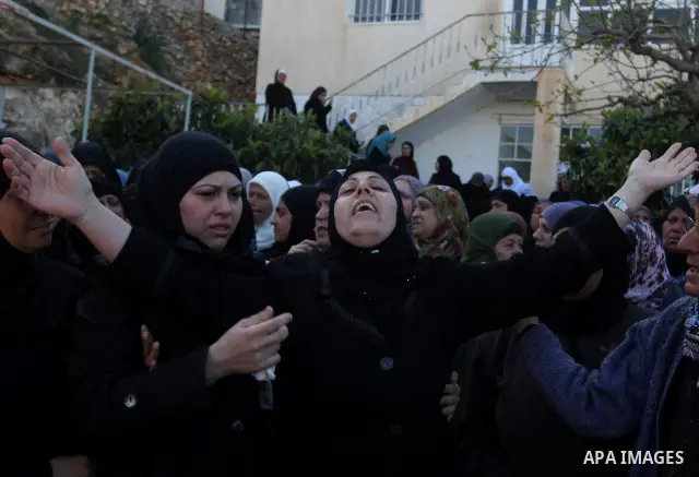 Palestinian women mourn during the funeral on April 2, 2012 in Rammun of Rashad Deeb, who was shot and injured by Israeli troops along with his two brothers in the early hours of March 27 in an incident in the West Bank...