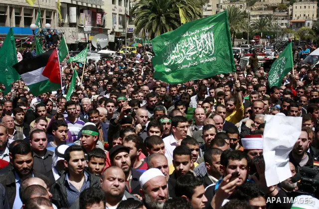 Palestinian mourners gather around the body of Sheikh Hamed Al-Betawi member of the Legislative Council for Hamas during his funeral in the West Bank city of Thursday, April 5, 2012 . Photo by Wagdi Eshtayah