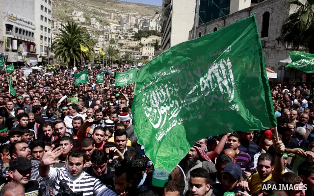 Palestinian mourners gather around the body of Sheikh Hamed Al-Betawi member of the Legislative Council for Hamas during his funeral in the West Bank city of Thursday, April 5, 2012 . Photo by Wagdi Eshtayah