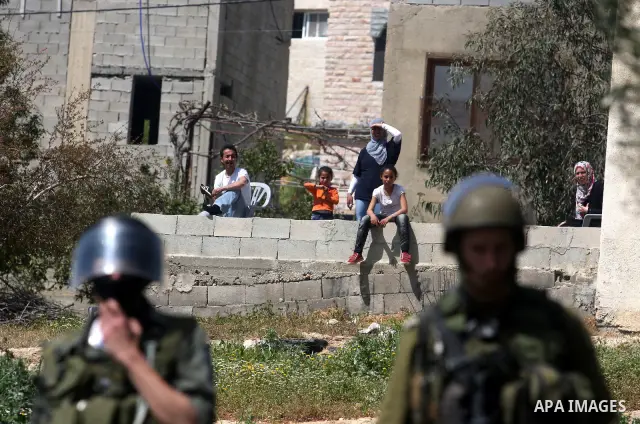 Israeli soldiers stand guard during clashes with palestinian who protest against Palestinian land confiscation to expand the Jewish Hallamish settlement in the West Bank village of Nabi Saleh, near Ramallah, on April 6,...