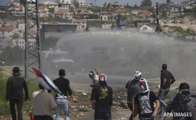 Palestinian protesters confront Israeli troops during a demonstration in the village Kafr Qaddum, close to the northern town of Nablus in the occupied Israeli West Bank on April 06, 2012. Photo by Wagdi Eshtayah