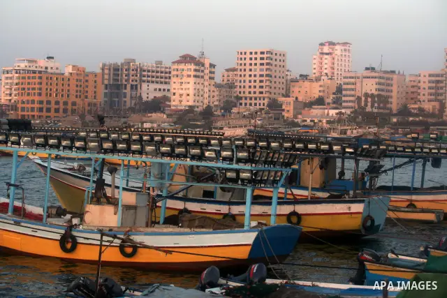 Palestinian fishermen are seen silhouetted on their boat in the Mediterranean sea during sunset to the West of Gaza city, 06 April 2012. Photo by Emad Nassar