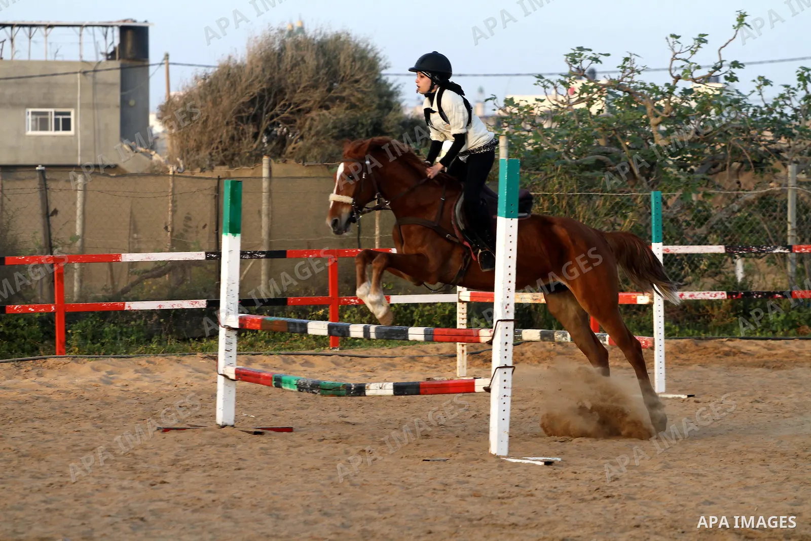 A Palestinian girl rides a horse during a championship at Gaza Horse Club in Gaza Strip, 06 April 2012. The clubs is home to some 54 horses and open for the training of male and female children aged between 12 to 23 year...