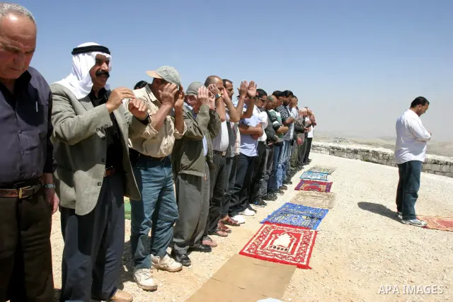 Palestinians pray on a street during Friday noon prayers on Apr. 06, 2012 in the East Jerusalem. Photo by Mahfouz Abu Turk