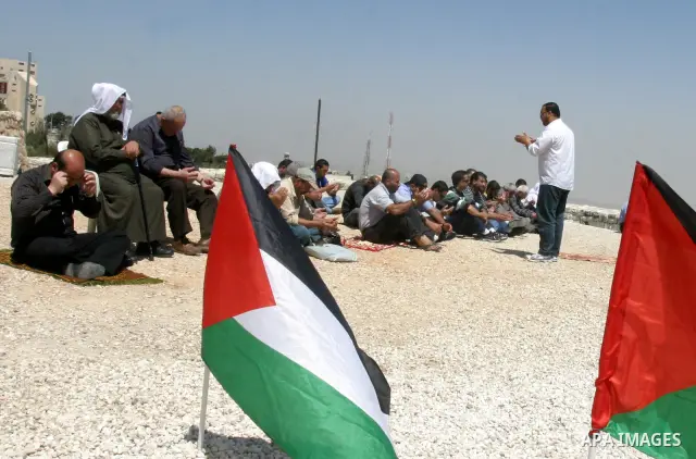 Palestinians pray on a street during Friday noon prayers on Apr. 06, 2012 in the East Jerusalem. Photo by Mahfouz Abu Turk