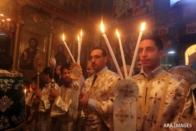 Palestinian Christian Catholics attend an Easter Vigil mass in Gaza City on April 8, 2012. Christians around the world mark the Holy Week of Easter to commemorate the crucifixion and resurrection of Jesus Christ. Photo b...