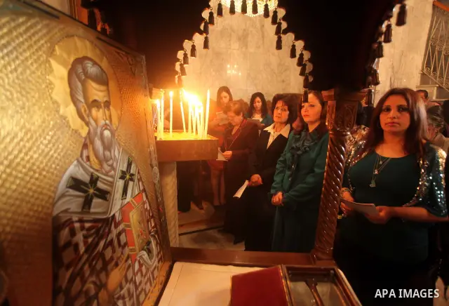 Palestinian Christian Catholics attend an Easter Vigil mass in Gaza City on April 8, 2012. Christians around the world mark the Holy Week of Easter to commemorate the crucifixion and resurrection of Jesus Christ. Photo b...