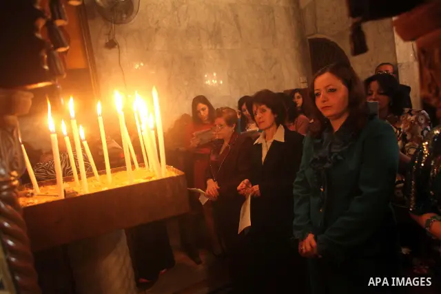 Palestinian Christian Catholics attend an Easter Vigil mass in Gaza City on April 8, 2012. Christians around the world mark the Holy Week of Easter to commemorate the crucifixion and resurrection of Jesus Christ. Photo b...