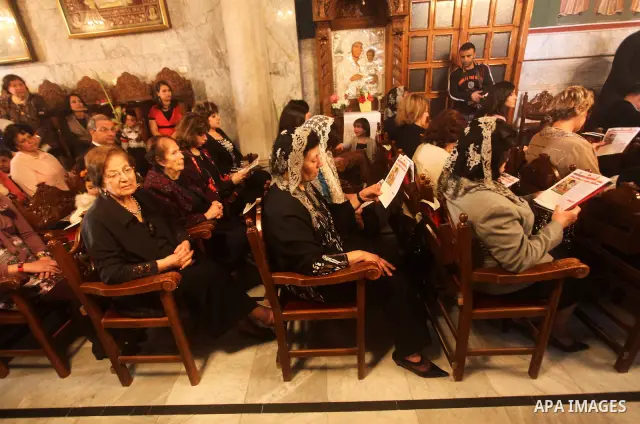 Palestinian Christian Catholics attend an Easter Vigil mass in Gaza City on April 8, 2012. Christians around the world mark the Holy Week of Easter to commemorate the crucifixion and resurrection of Jesus Christ. Photo b...