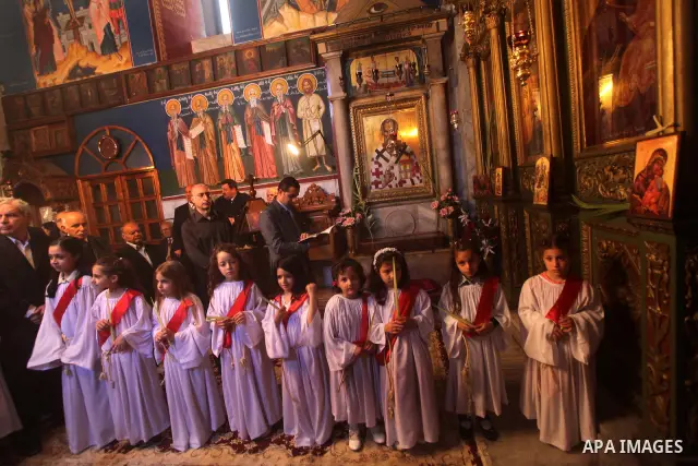 Palestinian Christian Catholics attend an Easter Vigil mass in Gaza City on April 8, 2012. Christians around the world mark the Holy Week of Easter to commemorate the crucifixion and resurrection of Jesus Christ. Photo b...