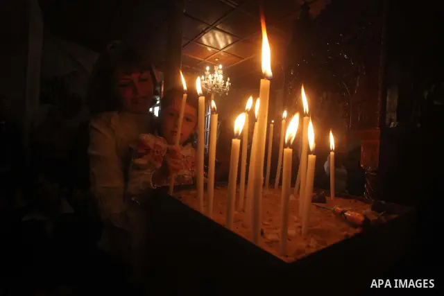 Palestinian Christian Catholics attend an Easter Vigil mass in Gaza City on April 8, 2012. Christians around the world mark the Holy Week of Easter to commemorate the crucifixion and resurrection of Jesus Christ. Photo b...