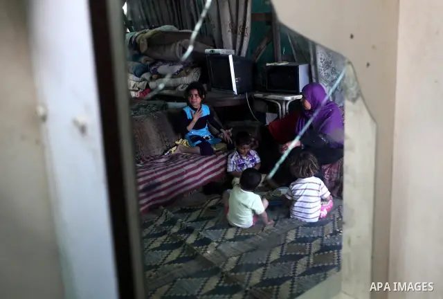 A Palestinian family eating inside his family house in a poor region of the Al-Nusirat neighborhood, central Gaza Strip on 08 April 2012. Reports from the World Bank on 06 April 2012 state that The World Banks Board of...