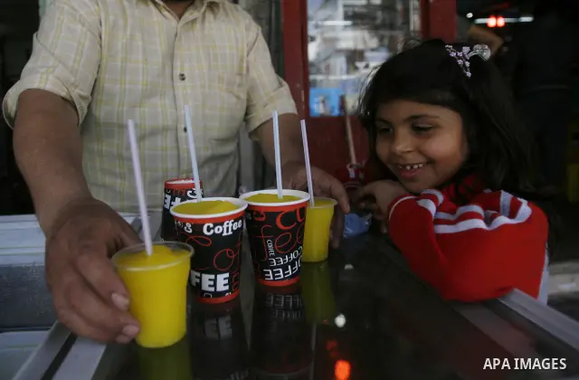 A Palestinian girl buys ice cream in the market in the southern Gaza Strip refugee camp of Rafah, in Apr. 08, 2012. Photo by Eyad Al Baba