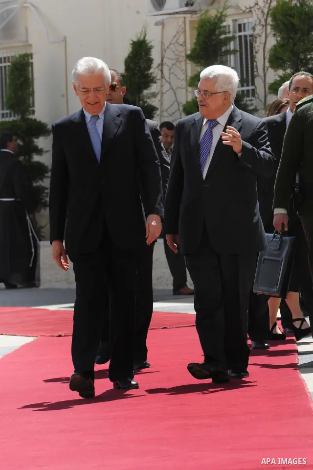 Palestinian President Mahmoud Abbas, meets with Italy's Prime Minister Mario Monti past an honour guard during a welcoming ceremony in the West Bank city of Ramallah April 8, 2012. Photo by Thaer Ganaim