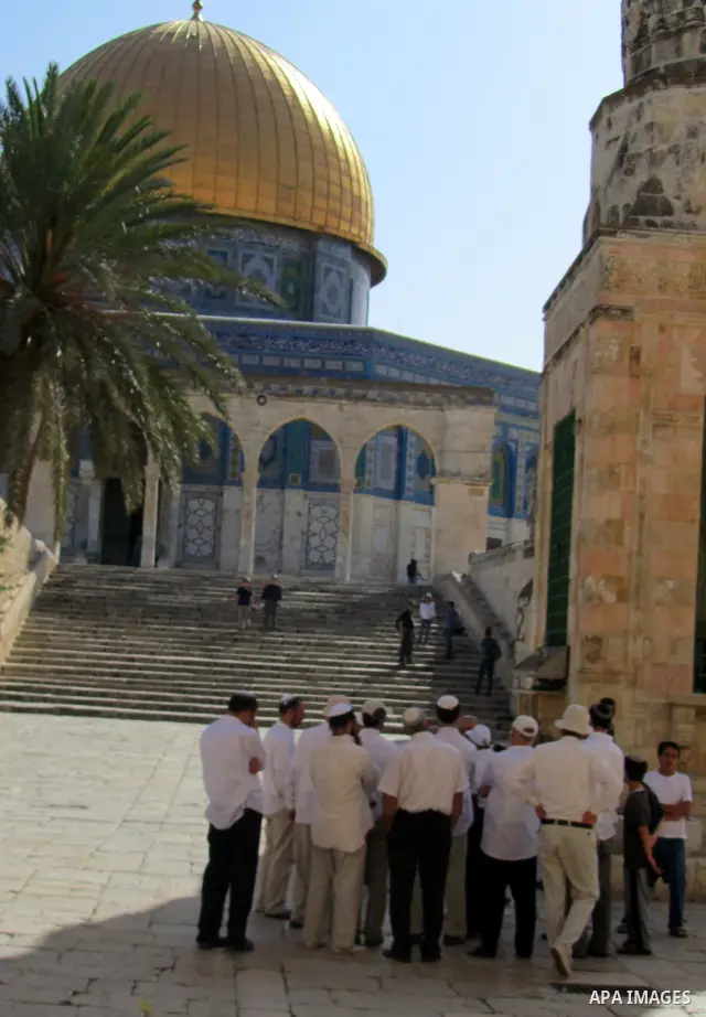 Jewish settlers stand in the yards of Al Aqsa Mosque in the old city of Jerusalem on Apr. 08, 2012. Photo by Mahfouz Abu Turk