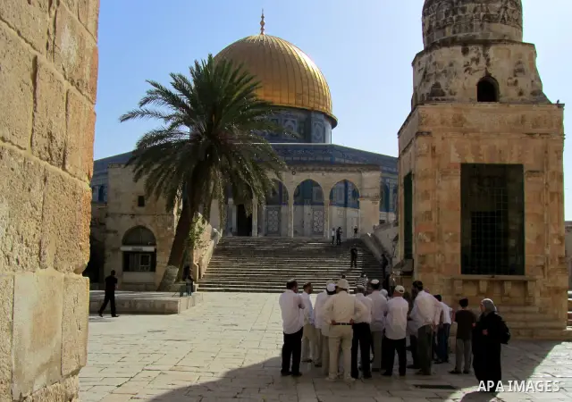 Jewish settlers stand in the yards of Al Aqsa Mosque in the old city of Jerusalem on Apr. 08, 2012. Photo by Mahfouz Abu Turk