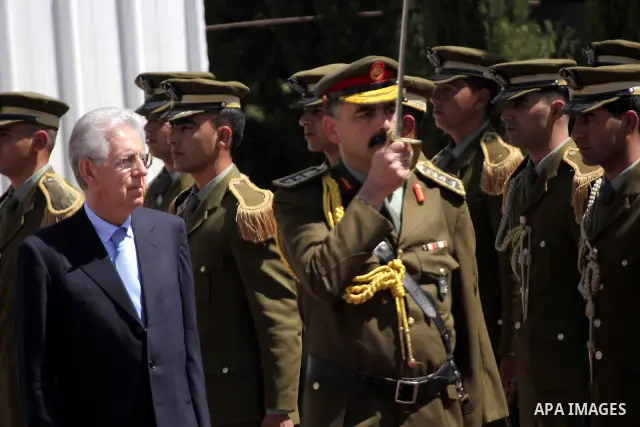 Palestinian President Mahmoud Abbas gestures meets with Italy's Prime Minister Mario Monti past an honour guard during a welcoming ceremony in the West Bank city of Ramallah April 8, 2012. Photo by Issam Rimawi