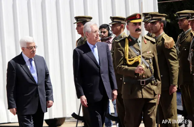 Palestinian President Mahmoud Abbas gestures meets with Italy's Prime Minister Mario Monti past an honour guard during a welcoming ceremony in the West Bank city of Ramallah April 8, 2012. Photo by Issam Rimawi