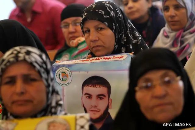 Palestinians hold pictures of their prisoned relatives in Israeli jails as they gather in a weekly activity calling for their liberty at the Red Cross headquarters in Gaza City on Apr. 09, 2012. Photo by Mohammed Asad
