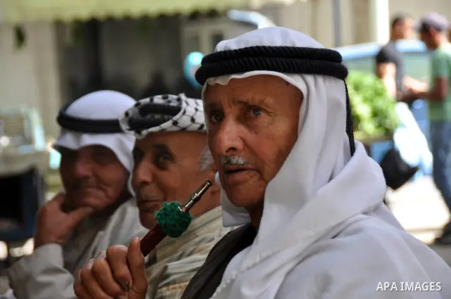 Palestinian elderly smoking waterpipes at cafe in the West Bank city of Nablus, on April, 10, 2012. Photo by Nedal Eshtayah