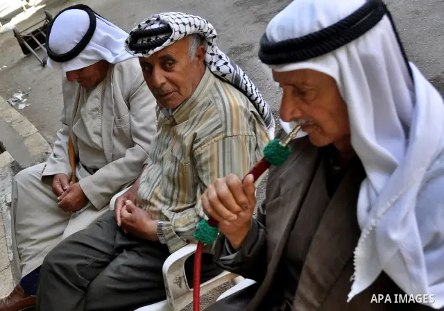 Palestinian elderly smoking waterpipes at cafe in the West Bank city of Nablus, on April, 10, 2012. Photo by Nedal Eshtayah