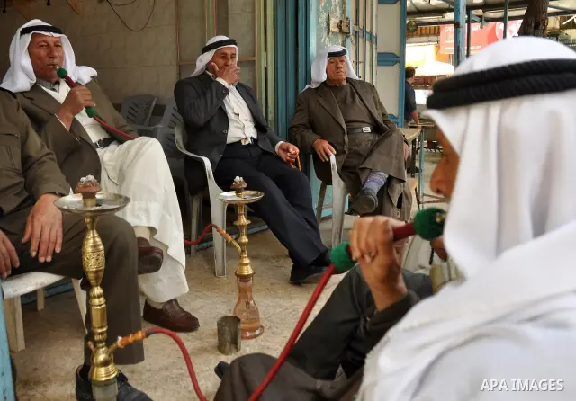 Palestinian elderly smoking waterpipes at cafe in the West Bank city of Nablus, on April, 10, 2012. Photo by Nedal Eshtayah