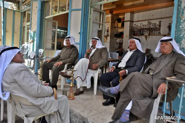 Palestinian elderly smoking waterpipes at cafe in the West Bank city of Nablus, on April, 10, 2012. Photo by Nedal Eshtayah