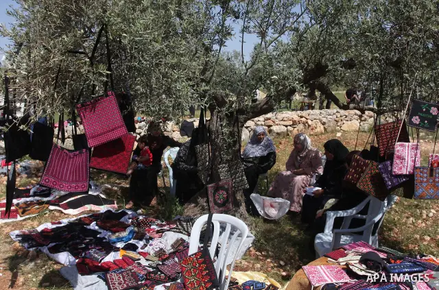 Palestinian Prime Minister Salam Fayyad, (not seen) participates in the Sixth International Conference of the Bil'in popular resistance, in the village of Bil'in, in the West Bank city of Ramallah April 10, 2012. Photo b...