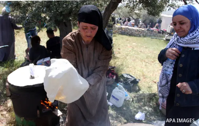Palestinian Prime Minister Salam Fayyad, (not seen) participates in the Sixth International Conference of the Bil'in popular resistance, in the village of Bil'in, in the West Bank city of Ramallah April 10, 2012. Photo b...