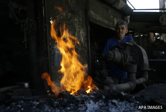 A Palestinian man works at a metal workshop in Rafah, southern Gaza Strip on April 10, 2012. Gaza has been in the grip of a severe power crisis for months now, with its sole electricity plant unable to function because o...