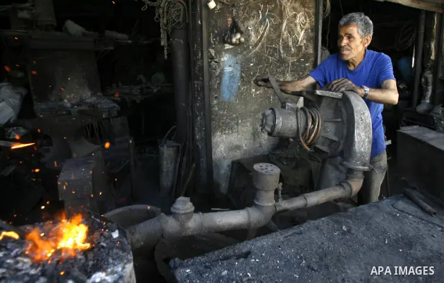 A Palestinian man works at a metal workshop in Rafah, southern Gaza Strip on April 10, 2012. Gaza has been in the grip of a severe power crisis for months now, with its sole electricity plant unable to function because o...