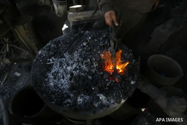 A Palestinian man works at a metal workshop in Rafah, southern Gaza Strip on April 10, 2012. Gaza has been in the grip of a severe power crisis for months now, with its sole electricity plant unable to function because o...