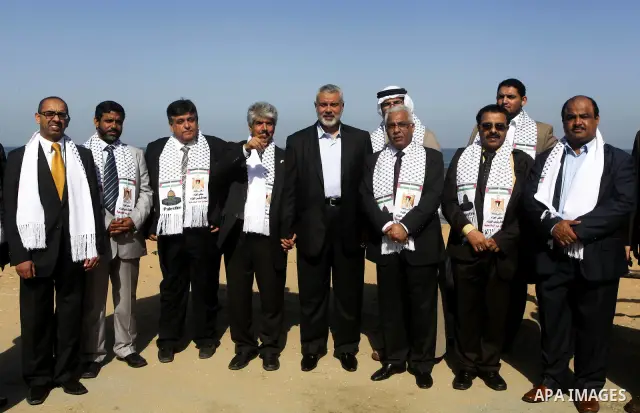 Palestinian Prime Minister in Gaza Strip, Ismail Haniya speaks with the Head of the Bahrani delegation during their tour to al-Shatea refugee camp in Gaza city on April 11,2012. The Bahrani delegation is in an official v...