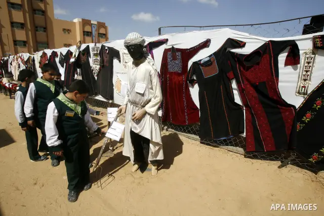 Palestinians take part in the exhibition for the palestinian heritage organized by Dar al-Fadela school in the southern Gaza Strip town of Rafah on April 11, 2012. The exhibition displays the Palestinian heritage works f...